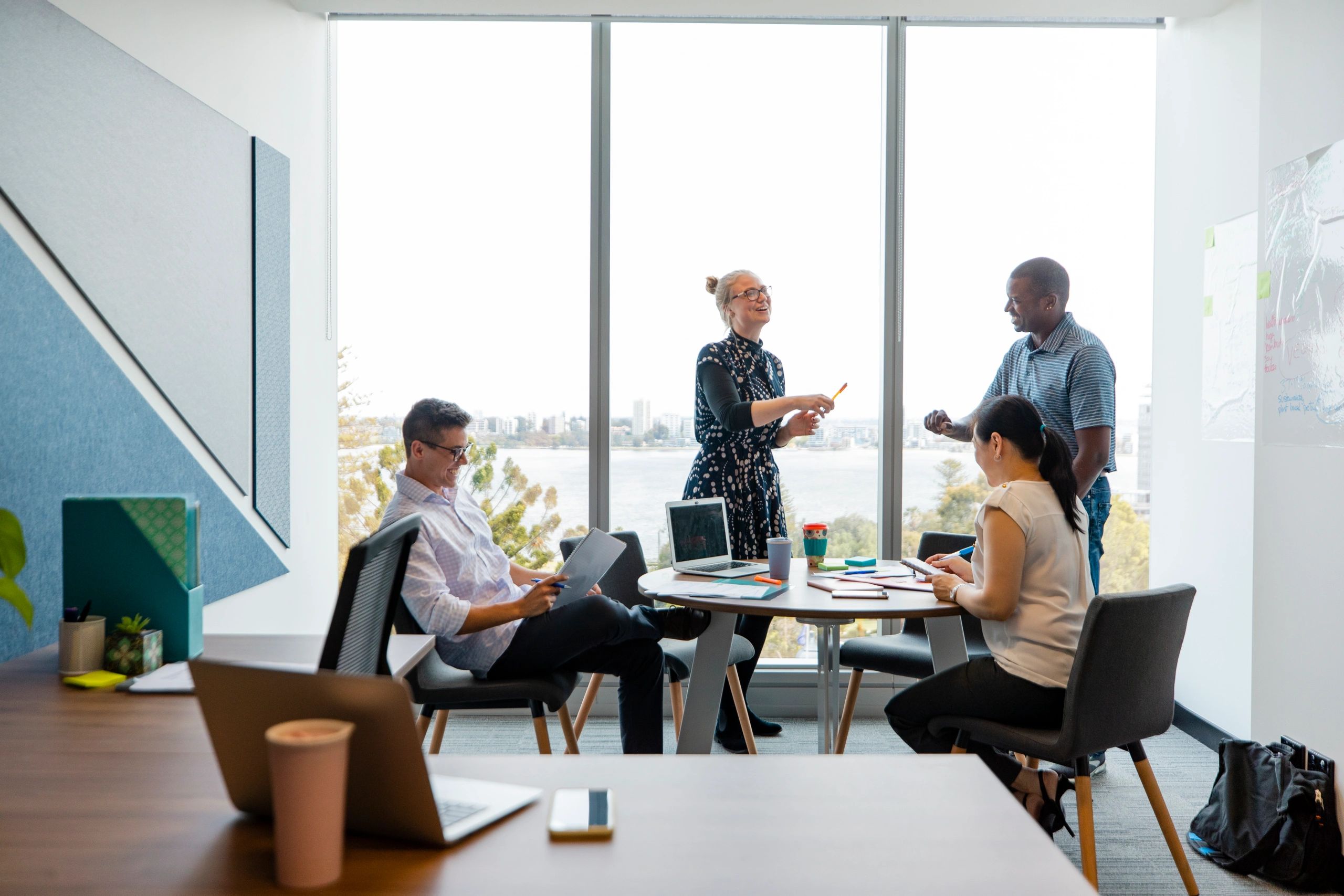 Team meeting with notes on the wall in a boardroom