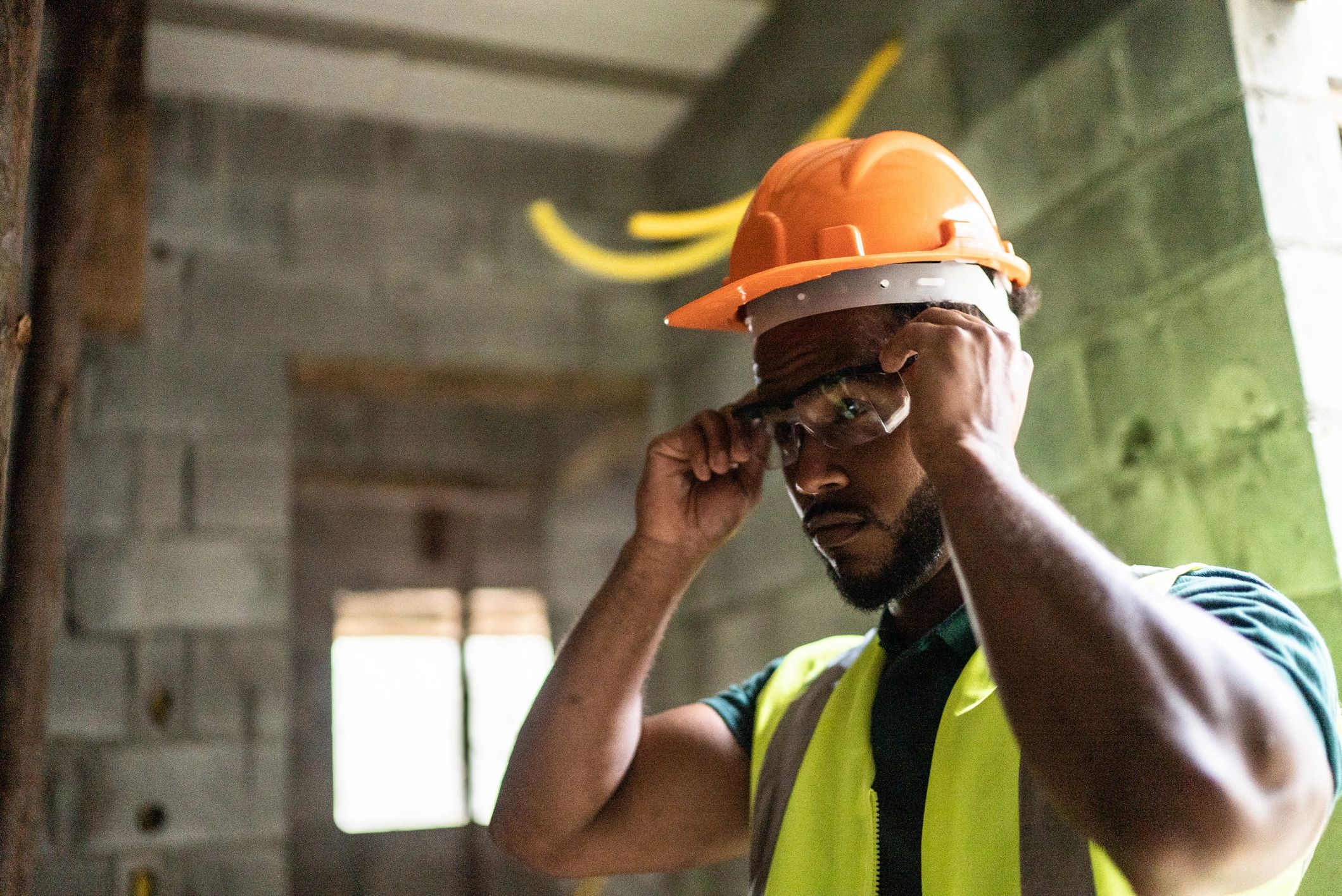 Construction worker putting on protective workwear