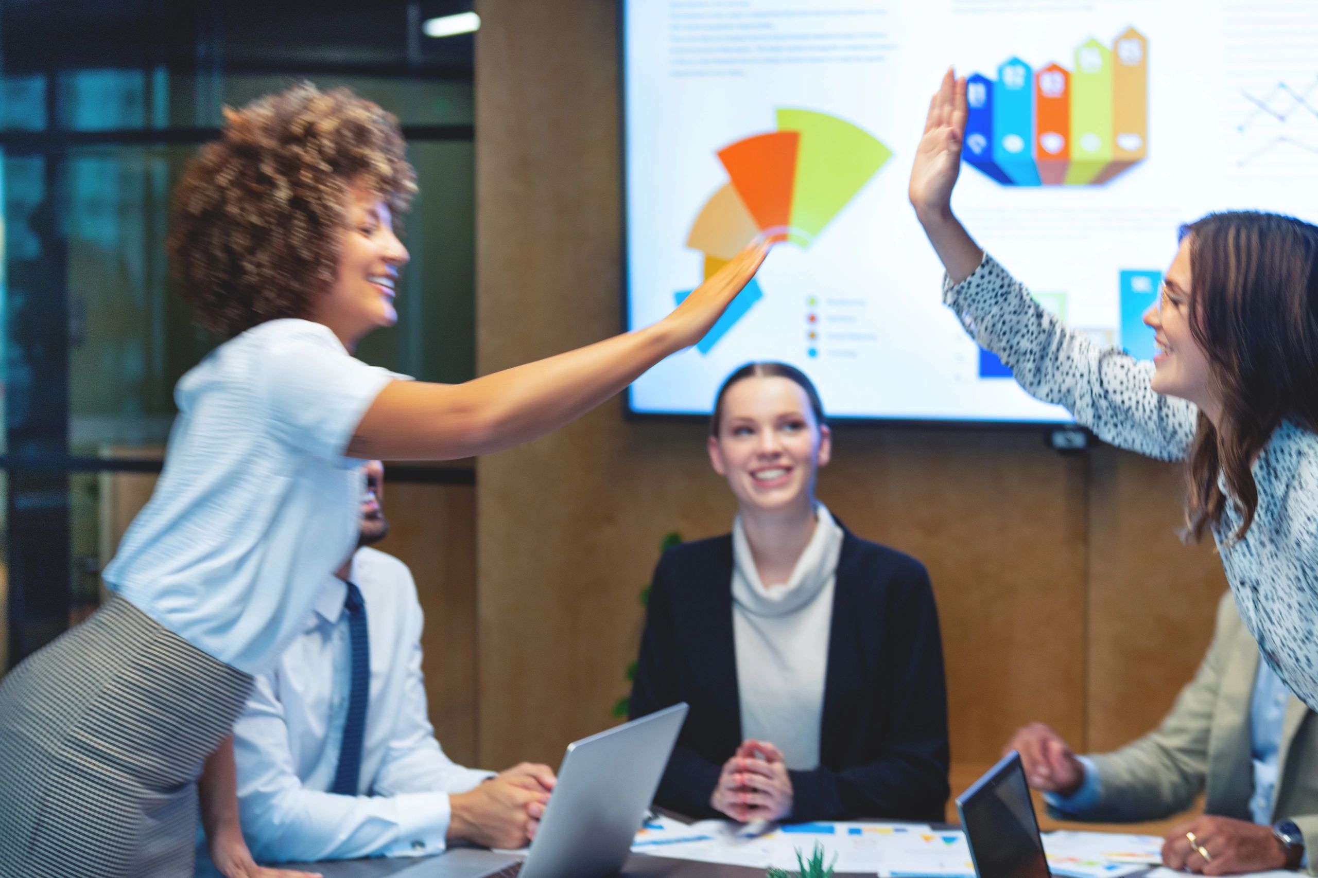 Business colleagues celebrating success in a meeting room