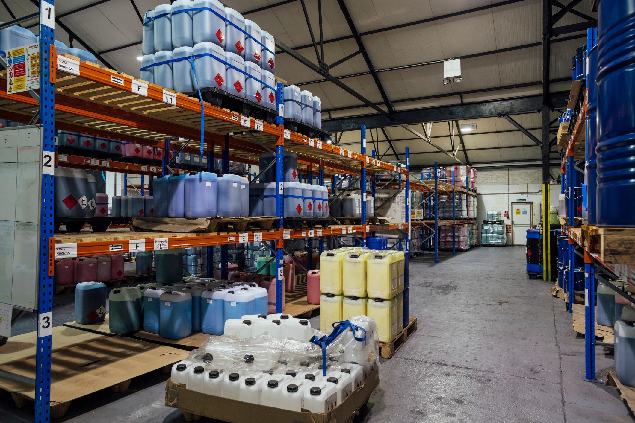 Industrial warehouse with containers and barrels