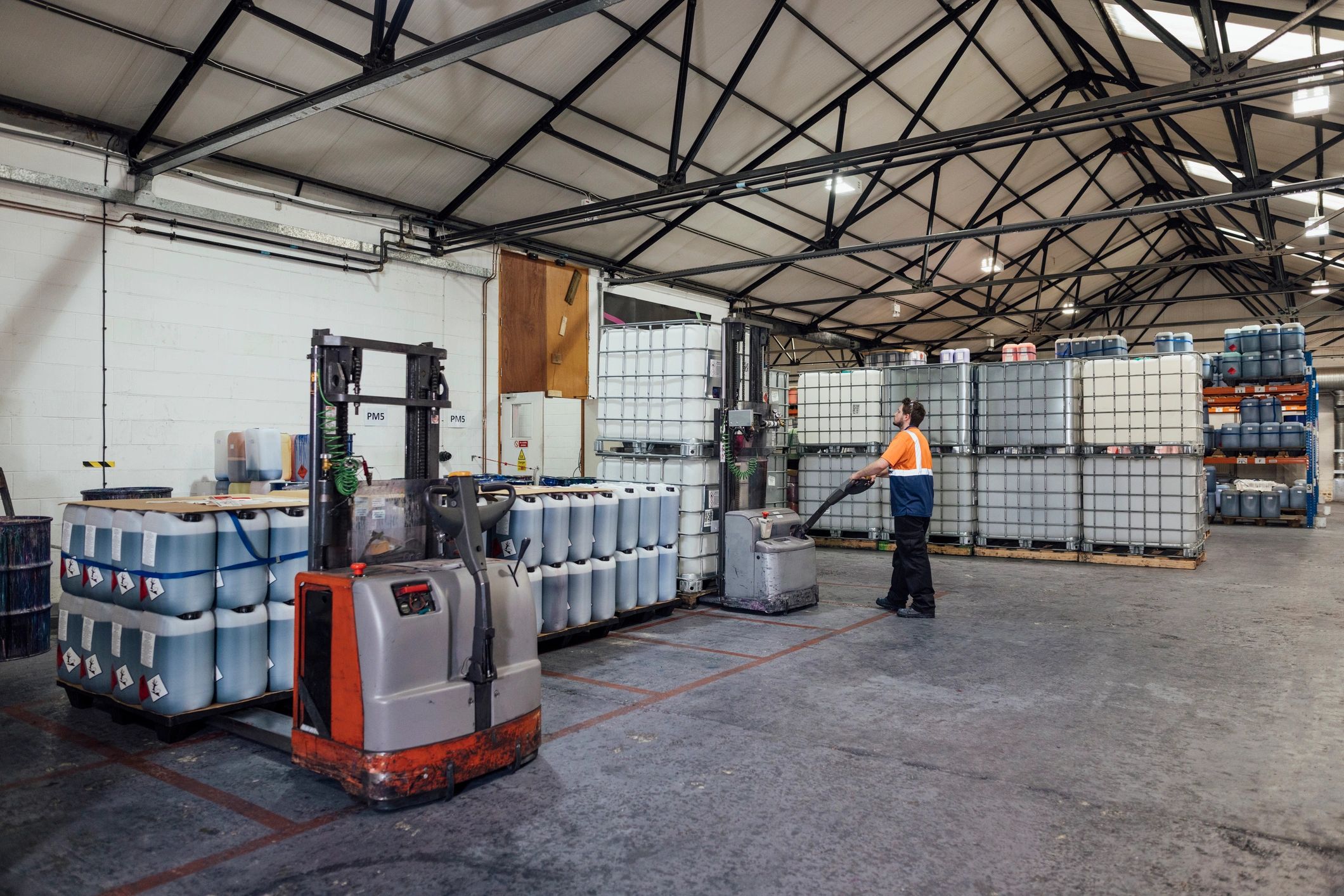 Warehouse worker moving stock with a pallet jack