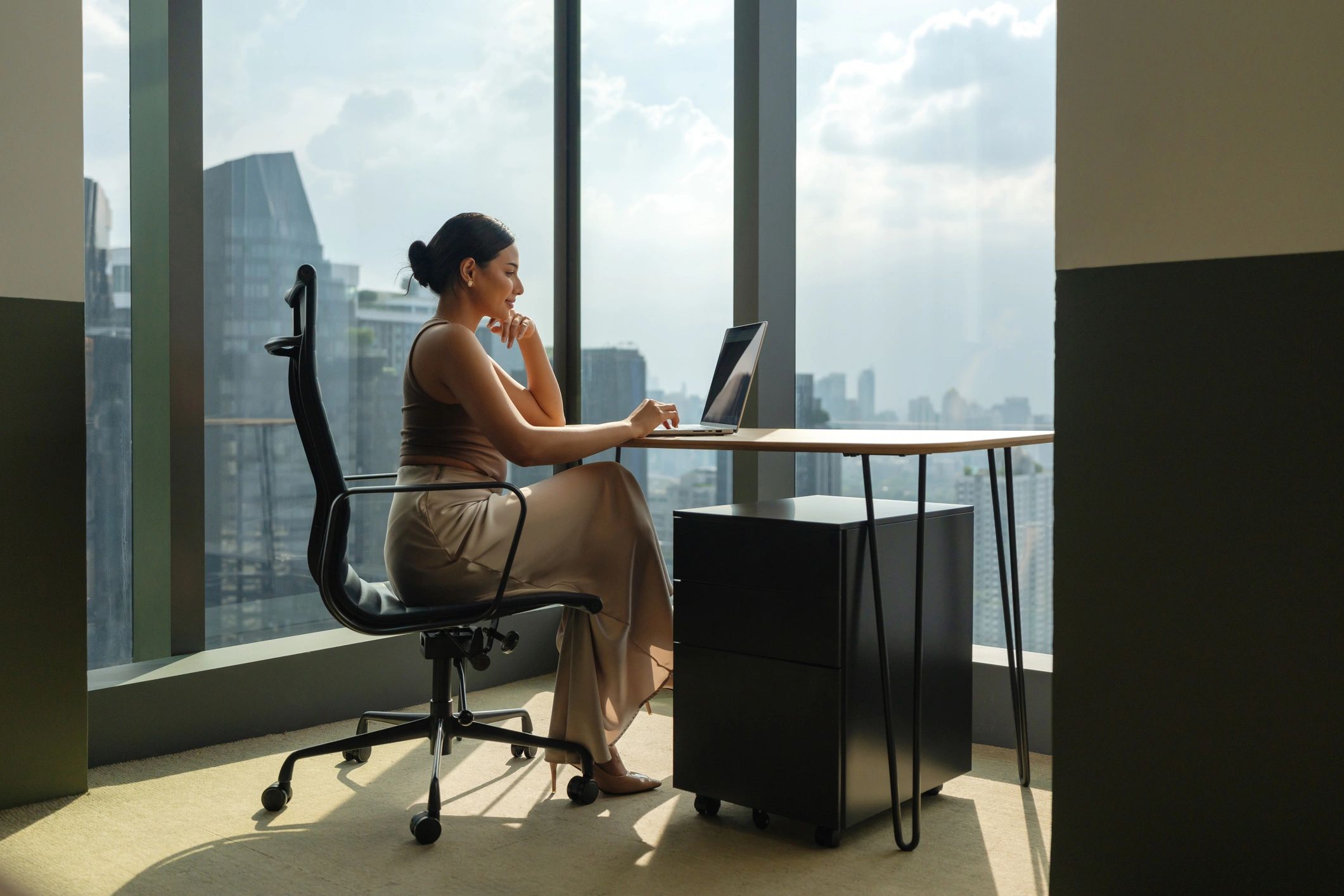 Businesswoman working on a laptop in a modern office