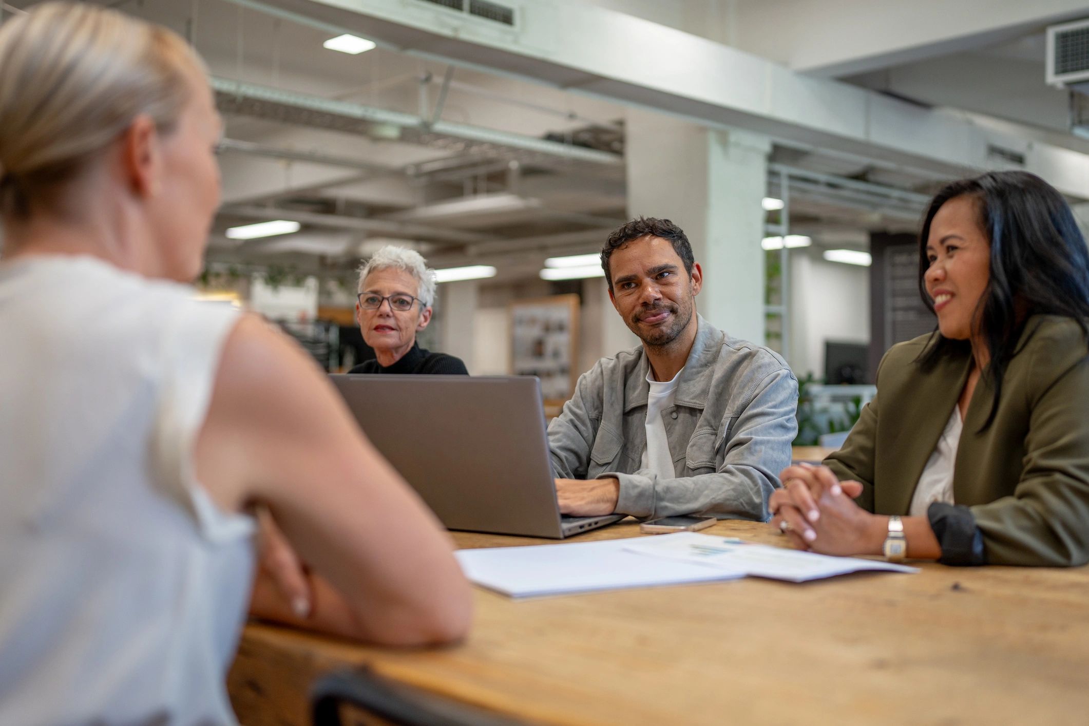 Professional leading a discussion in a modern corporate workspace