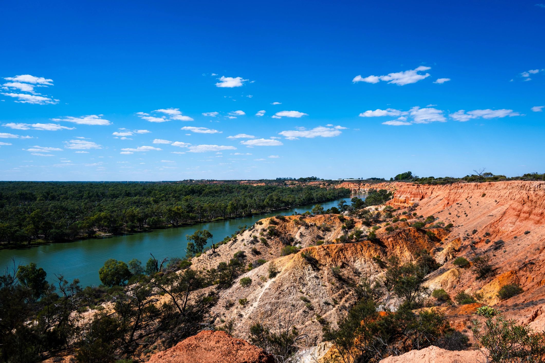 Ochre cliffs and river landscape with Australian bushland