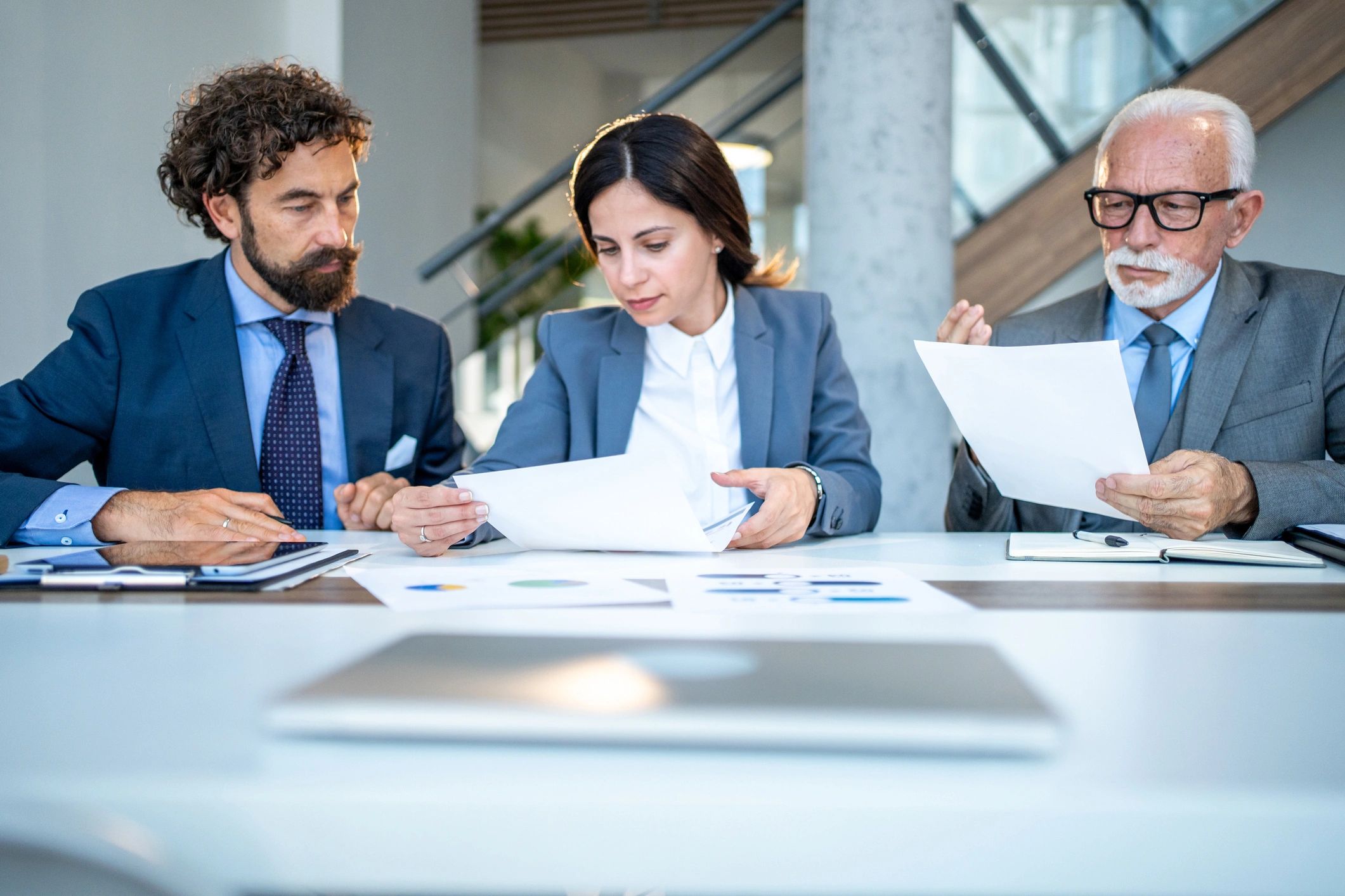Business team reviewing procurement documents and charts in a meeting