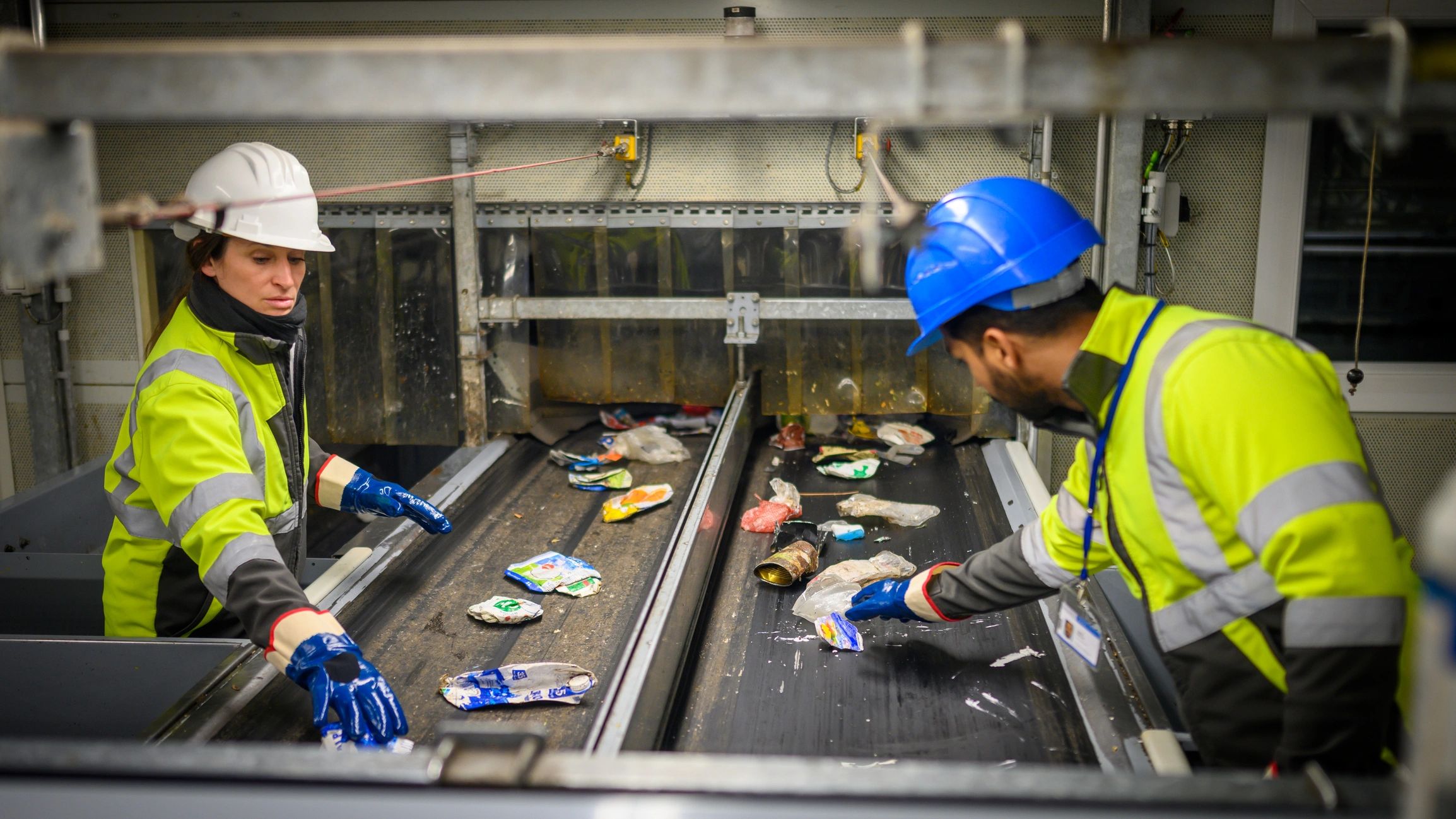 Workers in PPE at a materials processing facility