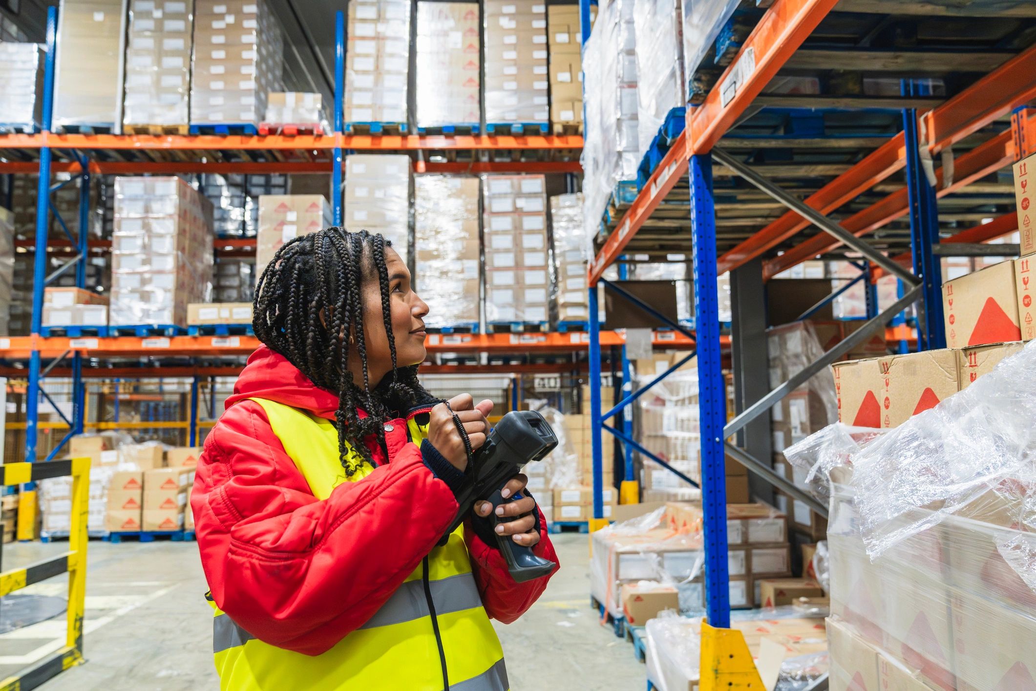 Worker scanning inventory in a warehouse